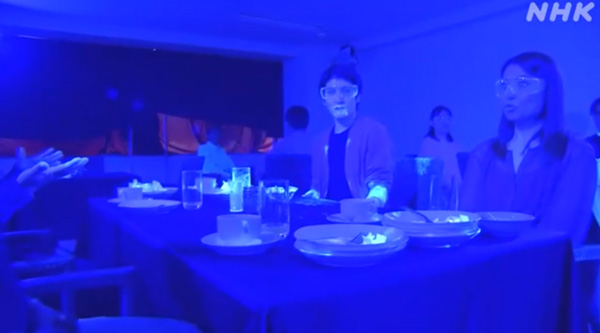 Blacklight experiment in a restaurant shows how quickly coronavirus spreads, even if a single person is infected.